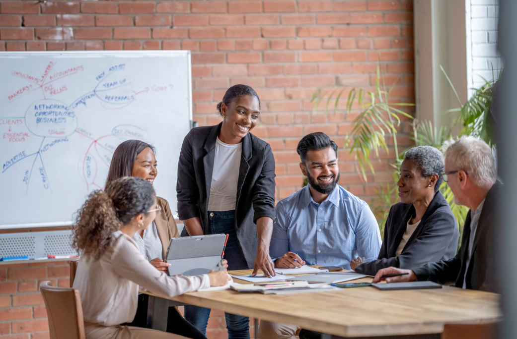 A woman facilitating a diverse group discussion